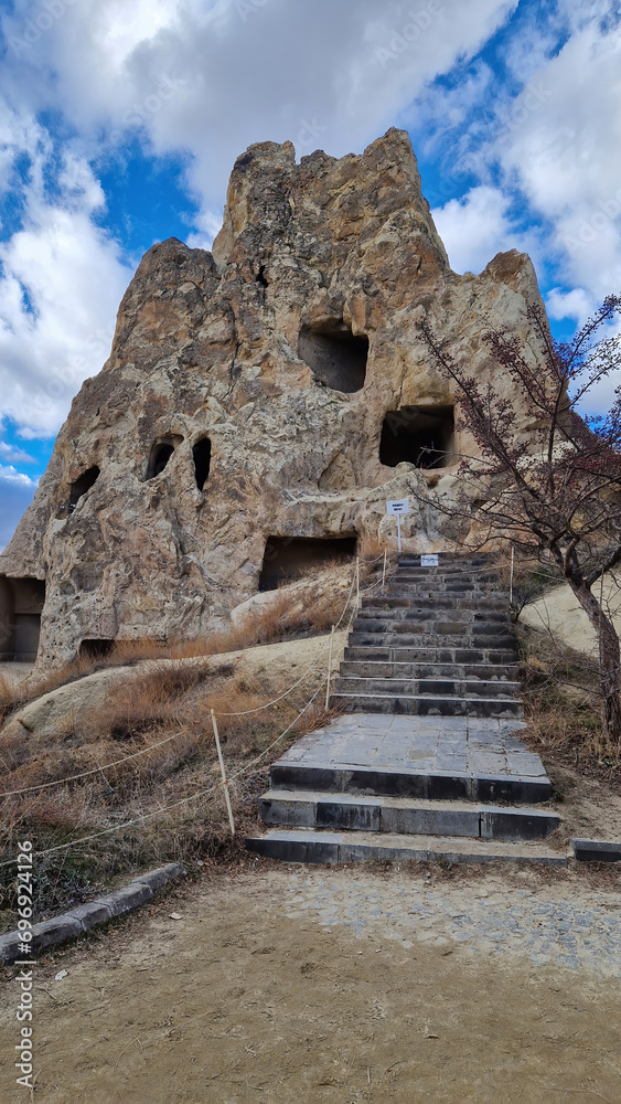 The exterior facade of a cave in Göreme Open Air Museum stands resilient, blending seamlessly with Cappadocia's iconic landscape.