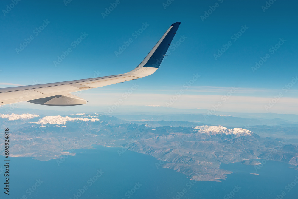 Fototapeta premium View of a snowy mountain from a window in airplane.