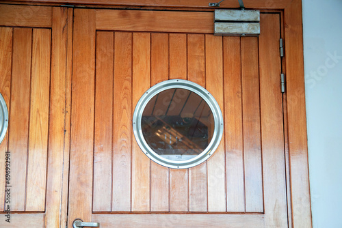 Porthole in the door on the ship. Cruise ship design. Passenger ship details. Round window, deck view
