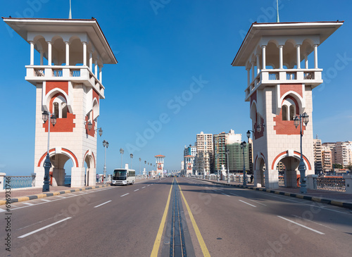 People walk the Stanley Bridge, popular landmark of Alexandria, Egypt photo