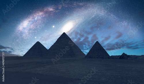Fototapeta Naklejka Na Ścianę i Meble -  The Milky Way rises over the Pyramids in Giza Andromeda Galaxy in the background - Egypt  
