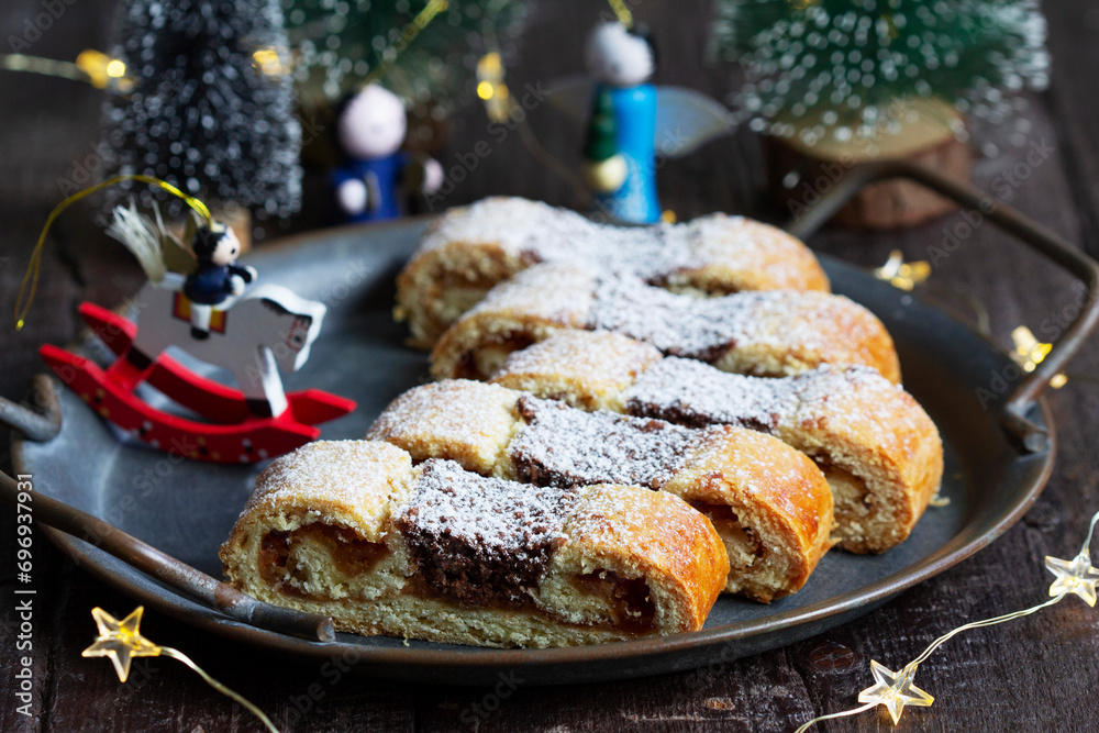 Grandfather's mustache cookies made from shortcrust pastry filled with nuts, jam and cocoa, Christmas toys and garland.
