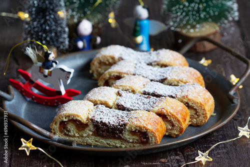 Obraz na płótnie Grandfather's mustache cookies made from shortcrust pastry filled with nuts, jam and cocoa, Christmas toys and garland. w salonie