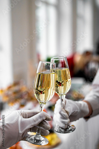 hands clinking champagne glasses for celebration