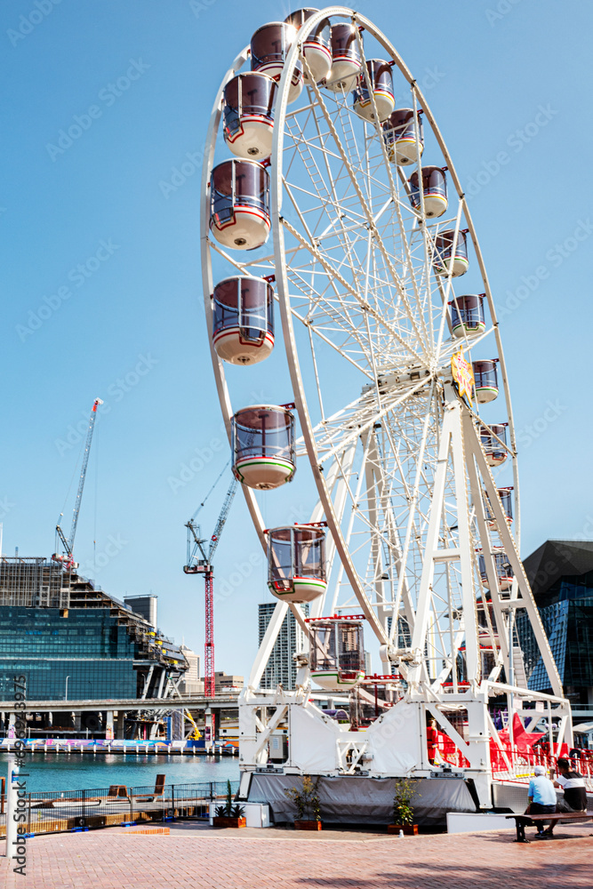 Ferris wheel at Darling Harbour. It is a harbor transformed into a public recreational facility, a tourist hot spot with museums, restaurants, amusement park and brand name stores. Sydney, Dec 2019