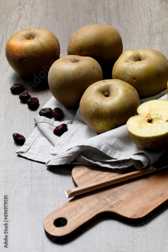 Pipping apples for compote on wooden board