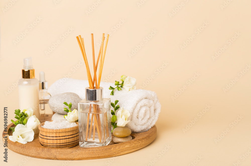 Spa composition with freesia flower and aroma diffuser on color background Spa composition with freesia flower and aroma diffuser on color background