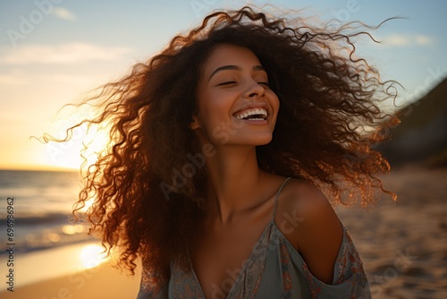 A stunning Latina woman with closed eyes, enjoying the sunset and the ocean breeze at the beach.