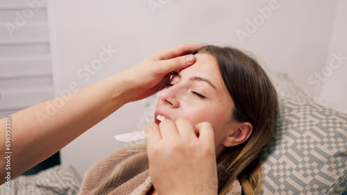The ENT doctor examines the patient's oral cavity in the office of the polyclinic with professional tools