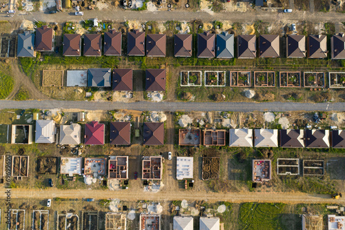 Construction of a suburban neighborhood of cottages. Aerial view.