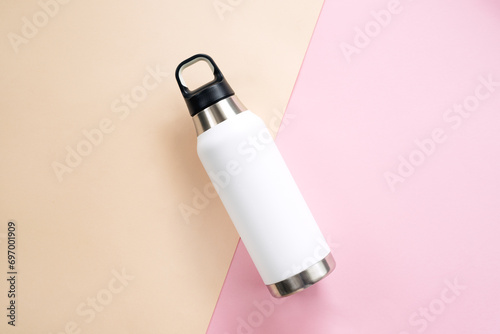 Reusable eco friendly sustainable water bottle on colour background. Copy space. Flat lay, top view. Zero waste, no plastic concept.