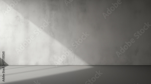 A beautiful original background image of an empty space in gray tones with a play of light and shadow on the wall and floor for design or creative work