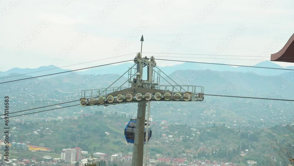 Funicular cable car cabin moves to destination, reaching the required point with ease. Recreational touristic experience against the overcast background. Tourist transportation on vacation