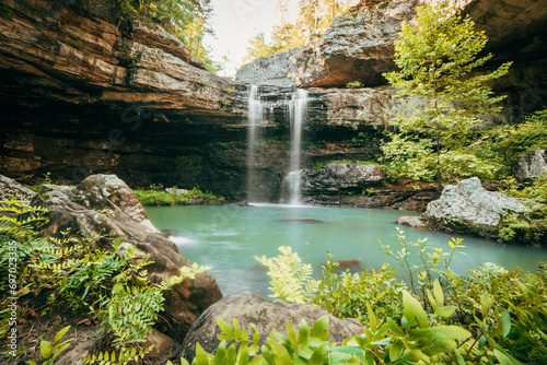 фотографія A secluded waterfall cascading into a beautiful pool