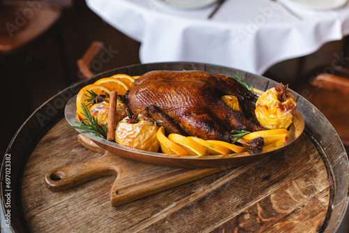 Christmas dinner. Roast duck with apples, oranges and cranberry sauce photo