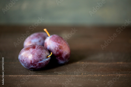 plums on a wooden table