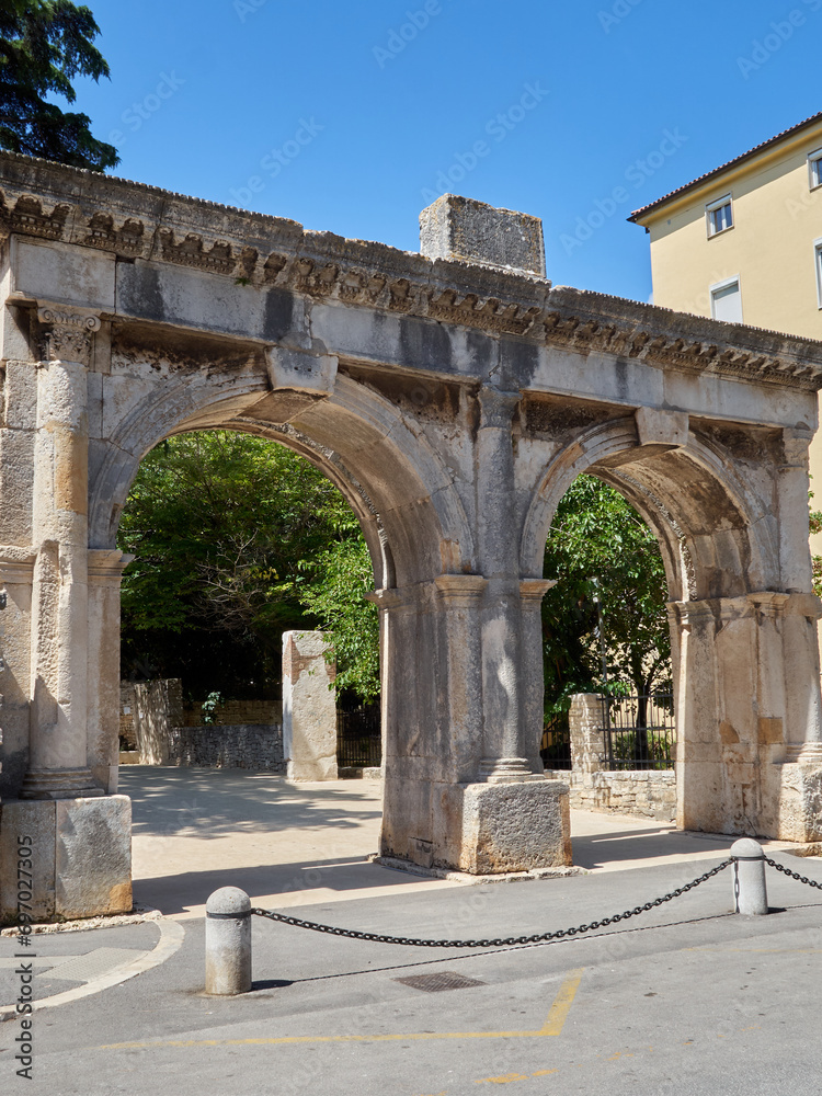 Twin gate. The Twin Gates or Porta Gemina is a roman double arched gate, part or the former walls and entrance to the city. Pula, Istria, Croatia, Europe