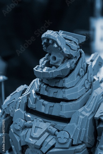 Art object printed on 3D printer. Robot toy created on 3D printer. High-precision 3D printing technologies. Creation of three-dimensional models. Modern new innovative technology.