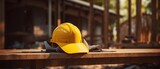 an yellow construction hard hat on a wooden bench