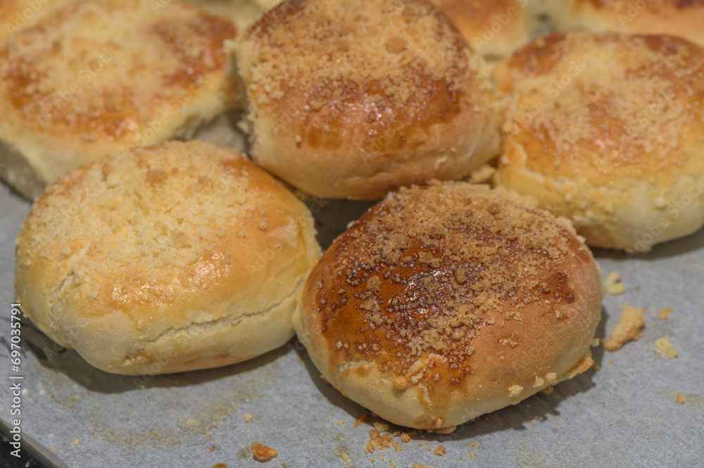 homemade bread rolls on parchment on a baking sheet 2