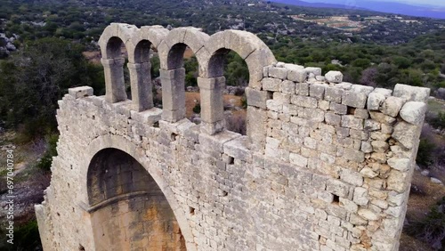 Drone hovers over Okuzlu, capturing Byzantine basilica remains. Okuzlu from above: Byzantine basilica remnants, aerial perspective. Byzantine basilica ruins in Okuzlu, viewed from drone