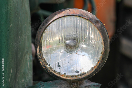 Cracked main headlight on an old tractor