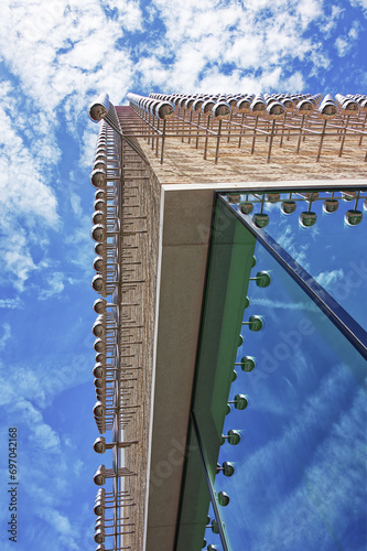 View from underneath of a modern building and the cloudy blue sky photo