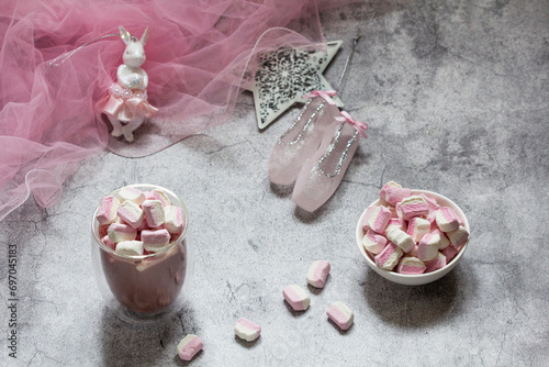 Obraz na płótnie Cocoa with marshmallows, Christmas tree decorations and pink tulle on a concrete background. w salonie