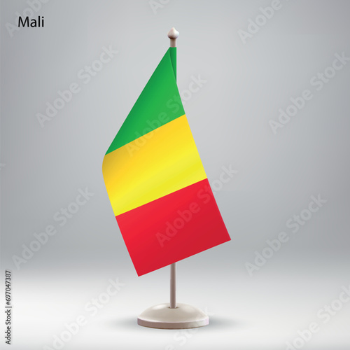 Flag of Mali hanging on a flag stand.
