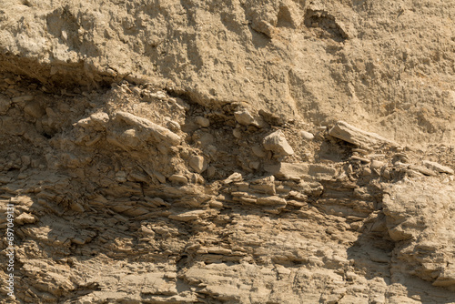 A stone slab near the Black Sea coast in close-up. Layered structure of sedimentary rocks. Coastal texture.