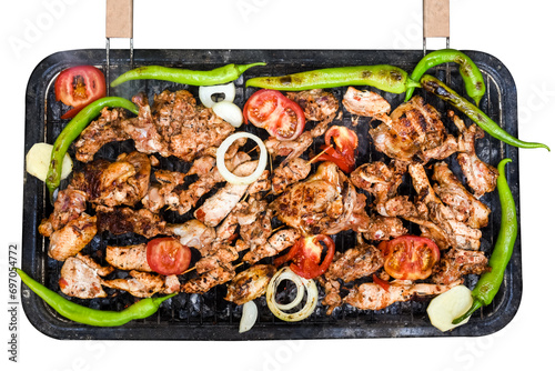 In a top angle view of assorted meat and vegetables grilling over a BBQ outdoor chicken legs isolated in white background.