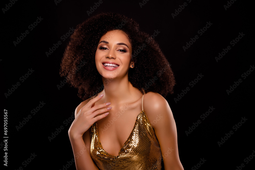 Portrait of gorgeous tender girl smile touch neck dressed trendy shiny golden outfit isolated on black color background Portrait of gorgeous tender girl smile touch neck dressed trendy shiny golden outfit isolated on black color background