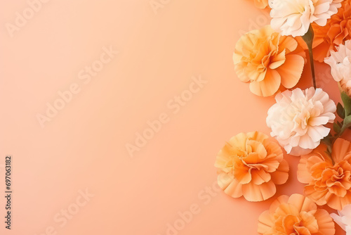 Ethereal marigolds and greeting card on orange-pink background  copy space  dreamy
