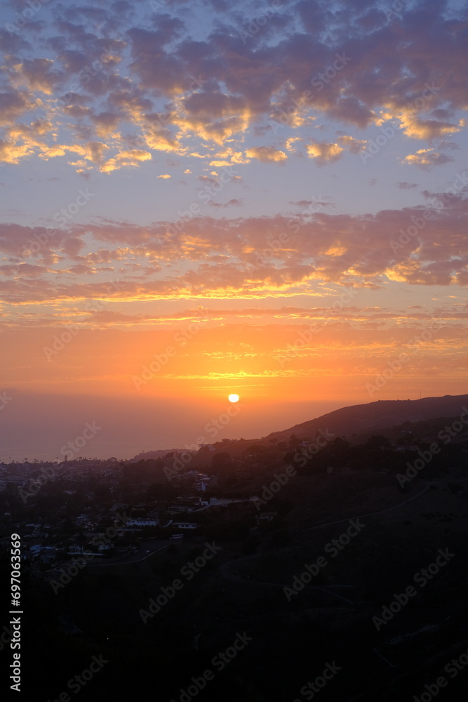bright sunset over the ocean and mountains