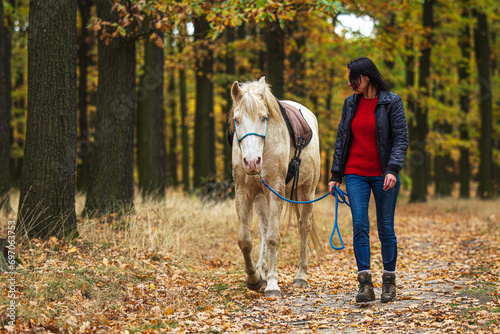 A pretty young woman and a white horse they're both happy © michal