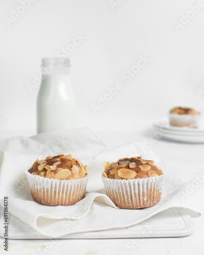 vanilla almond muffins on a white napkin, homemade bakery style almond muffins on a white background