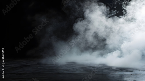 Empty dark background with smoke or fog on the floor.