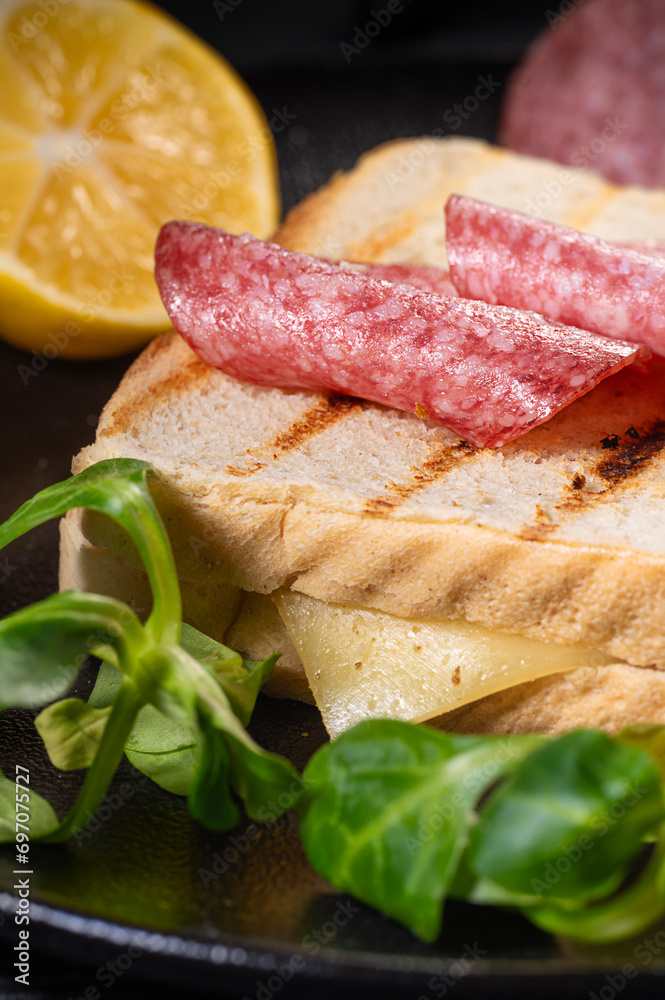 Sandwich with salami, herb cheese and lemon.