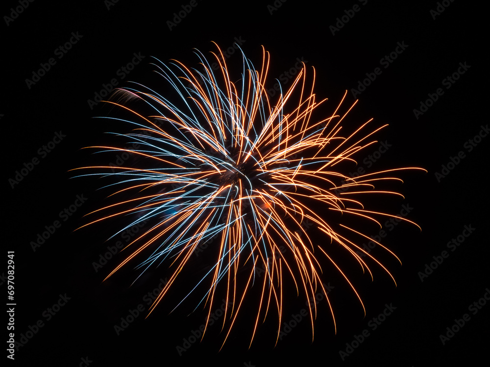 Fourth of july orange and blue fireworks exploding in the black sky for usa celebration Fourth of july orange and blue fireworks exploding in the black sky for usa celebration