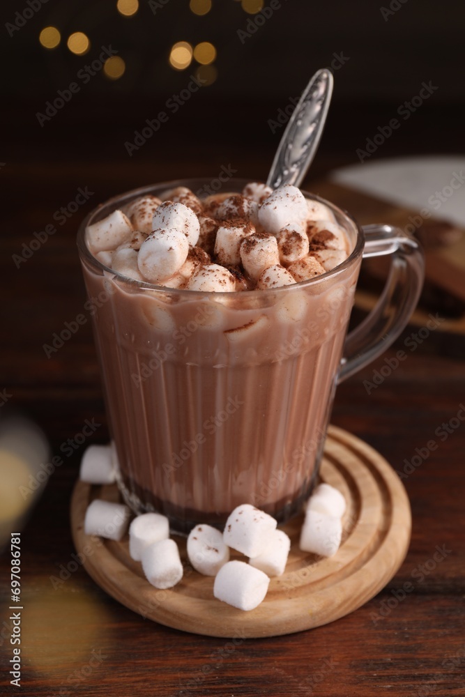 Cup of aromatic hot chocolate with marshmallows and cocoa powder on table, closeup Cup of aromatic hot chocolate with marshmallows and cocoa powder on table, closeup