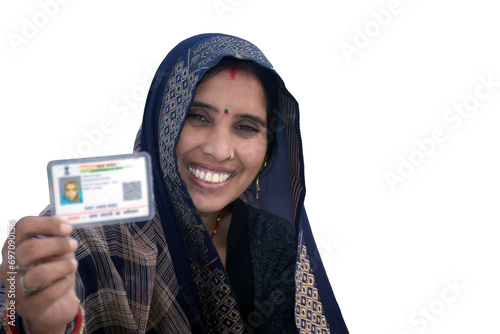 Indian rural woman wearing a sari with smiling face shows her blurred aadhar card in her hand, isolated white background photo