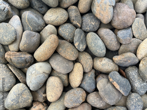 The oval pebbles on the ground form a background. texture for design decorative and wallpaper.