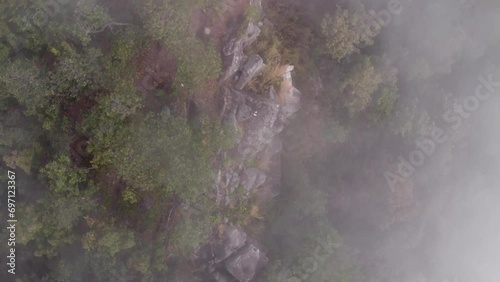 Winter travel in Thailand, drone flies over cliffs amid mist-shrouded mountains. Nature, Landscape and Travel concept