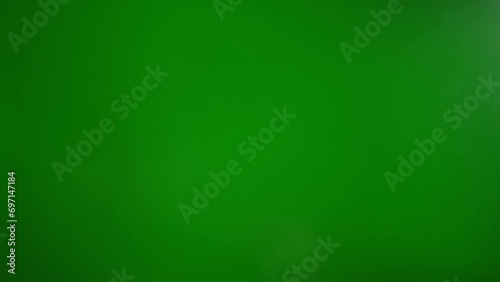 A man makes a fig with his fingers on a green background. The concept of resistance and contempt photo