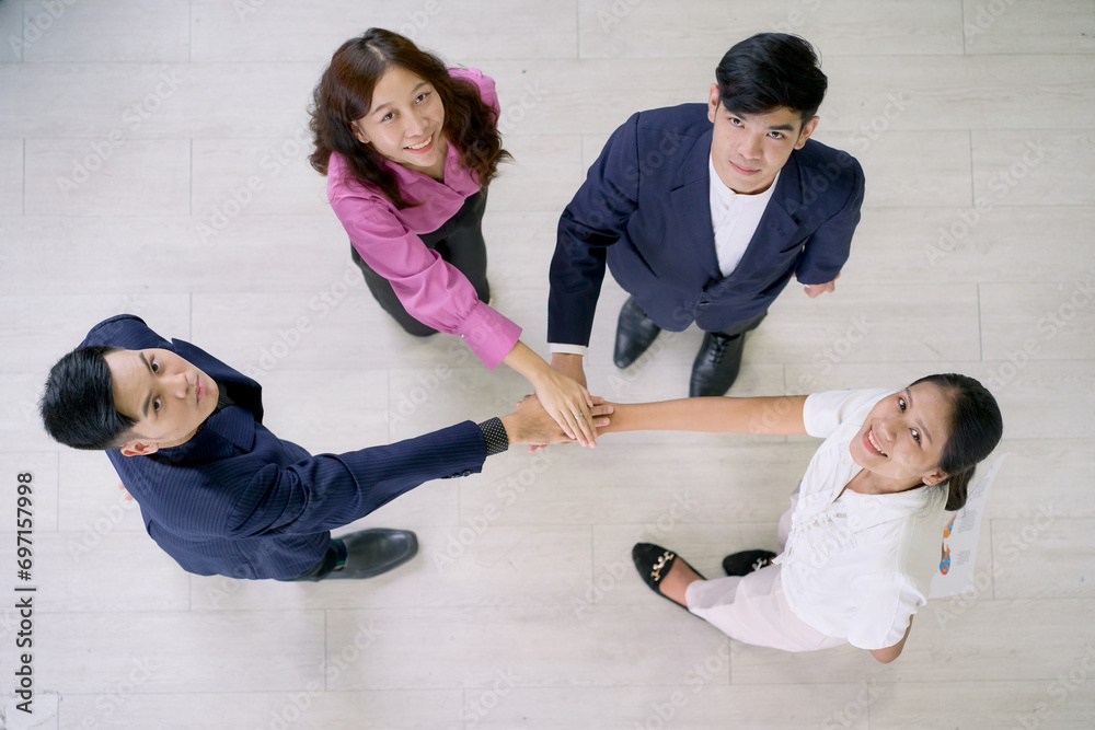 Fototapeta premium Top view of business team join hand concept for go to the same target.