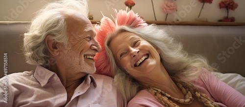 Elderly couple enjoying humorous and playful moments together while on vacation or relaxing in a bedroom.