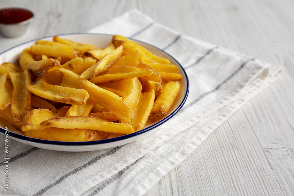 Homemade French Fries with Ketchup on a white wooden background, side view. Copy space. Homemade French Fries with Ketchup on a white wooden background, side view. Copy space.