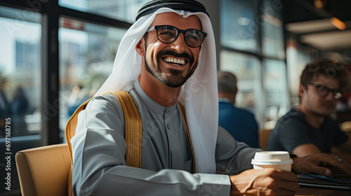 Happy Emirati Arab at office wearing Kandura photo