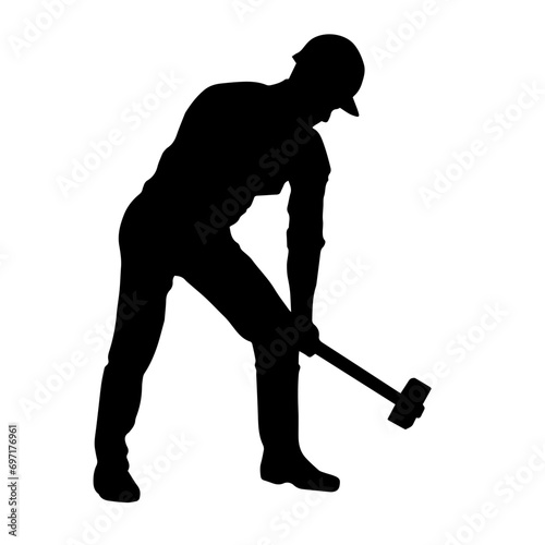 Silhouette of a worker in action pose using his sledge hammer tool.
