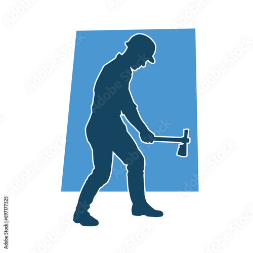 Silhouette of a worker in action pose using his axe tool.
